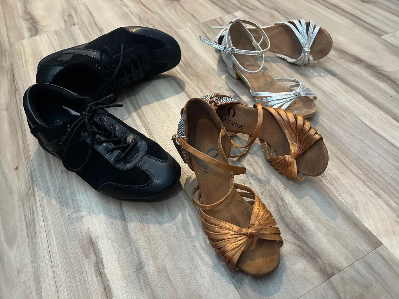 Suede-soled ballroom dance shoes and sandals on the Palladium's wood floor